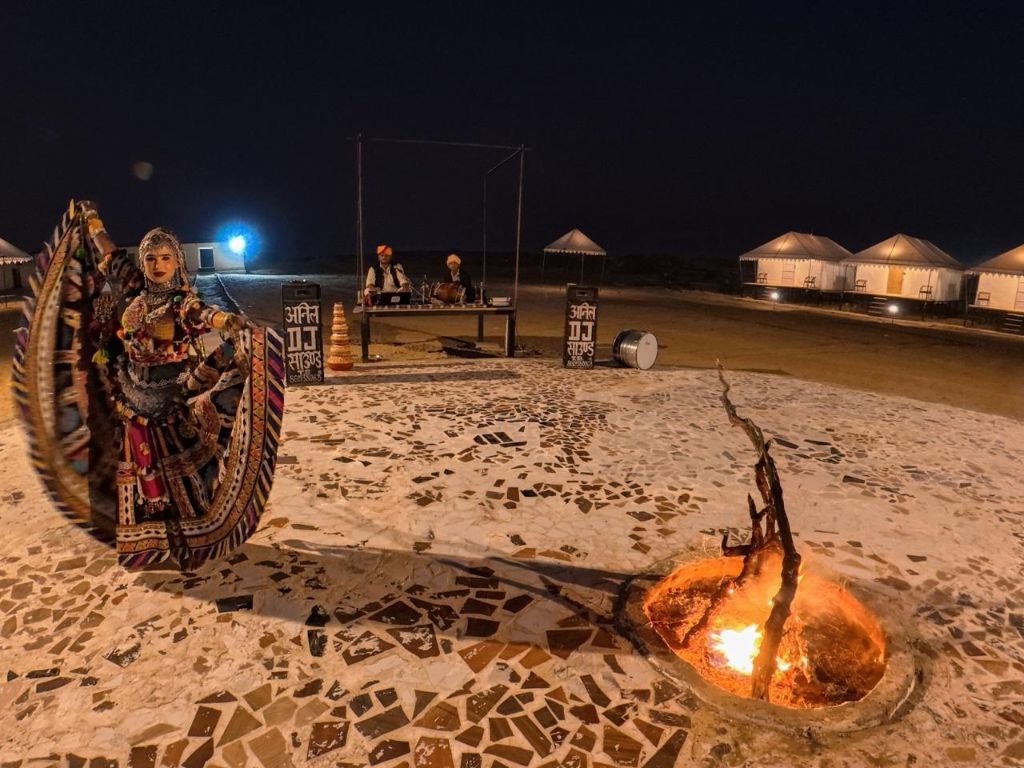 Ghoomar dance performance around bonfire at desert camp